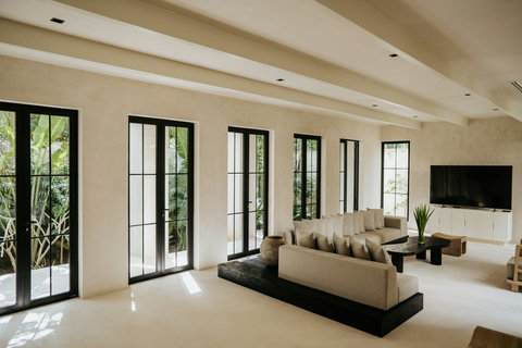 Minimalist modern living room designed for comfort, complete with a Smart TV and garden outlook