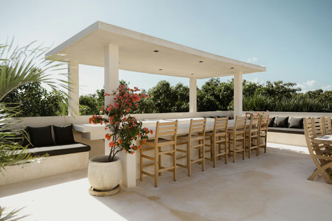 Rooftop retreat featuring a grill, bar stools, and built-in seating