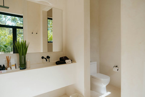 Minimalist bathroom with modern fixtures and a private toilet area