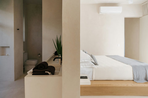 Cozy bedroom with a king-sized platform bed, AC and private bathroom