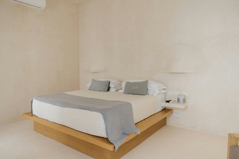 Sunlit bedroom with a luxurious king bed