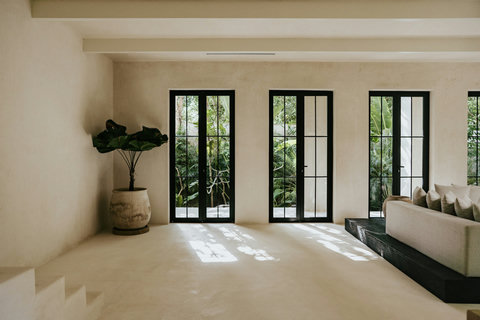 Elegant hallway with potted plants and garden views