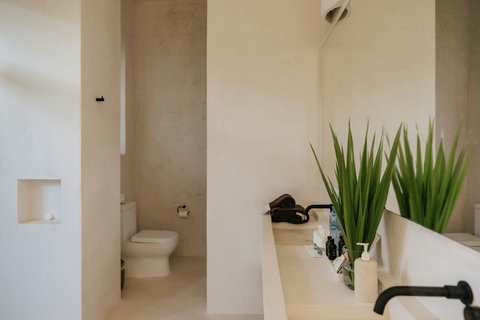 Modern bathroom with sleek fixtures and a private toilet area