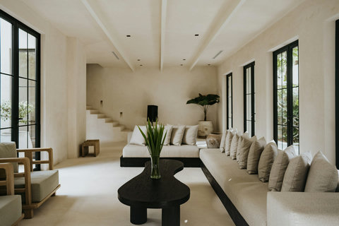 Stylish living room with architectural stairs, and lush garden outlook