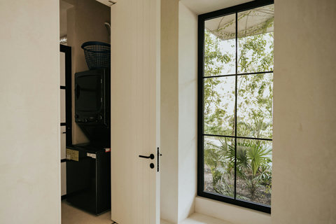 Well-lit laundry area with washer, dryer, and garden views