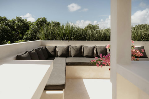 Relaxing lounge corner framed by natural greenery