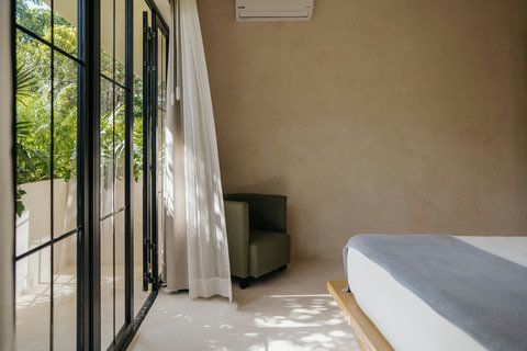 Sunlit bedroom with views and an accent chair