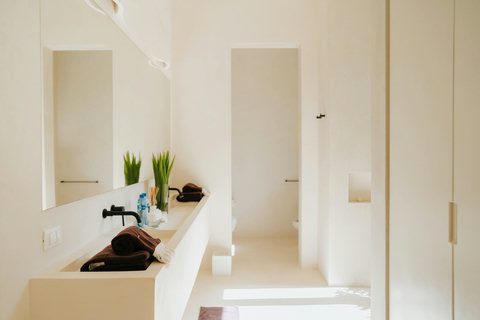 Modern bathroom with sleek fixtures and a separate toilet area