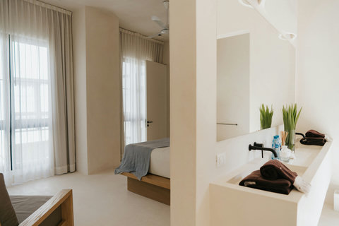 Cozy bedroom featuring a private bathroom