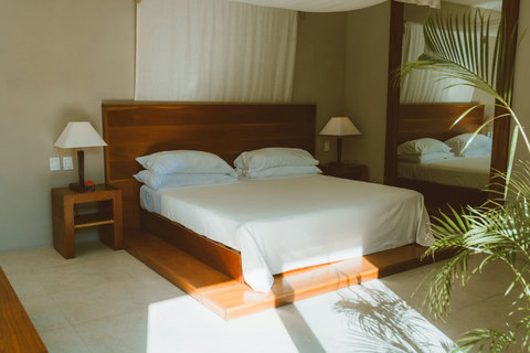 SUPERIOR DELUXE SUITE - Sunlit serenity in the bedroom.