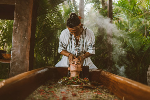 Herbal steam, cool leaves, and steady hands turn the open-air soak into a deeply grounding pause.