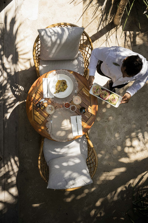 Dappled sunlight filters through palms as fresh flavors are served with effortless grace at your table.