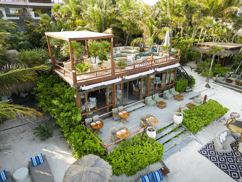 PANDANO RESTAURANT - An aerial view captures the harmony of wood and greenery, where elevated decks meet soft white sands.