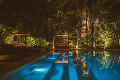 SWIMMING POOL NIGHT - Night drapes the courtyard, lantern-lit cabanas aglow, pool lanes shimmering cobalt for a moonlit float before dreams.