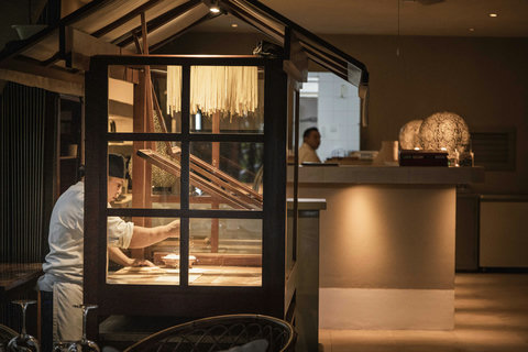 PANDANO RESTAURANT - Warm light spills from the kitchen window, revealing the quiet artistry behind every handcrafted dish.