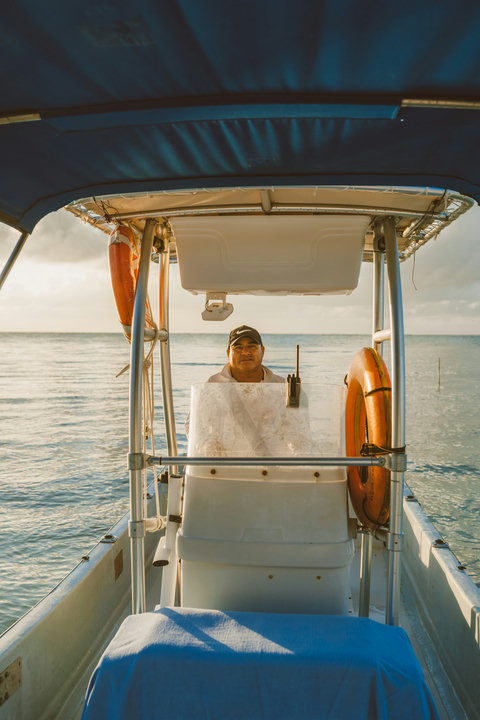 Your captain awaits at the helm, ready to guide you through calm waters under a soft, glowing sky.