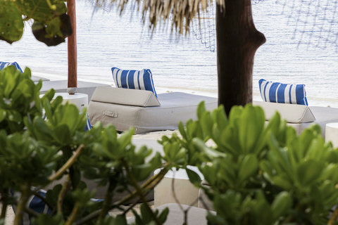 PRIVATE BEACH & BAY - Low tide hushes nearby, striped cushions wait beneath palapa shade for lazy stories and barefoot naps.