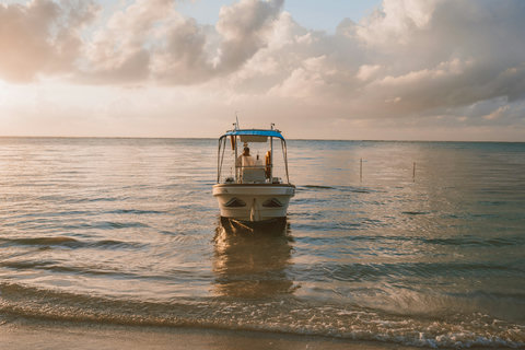 The boat floats serenely in the shallows, a quiet promise of adventure as the day gently fades into gold.