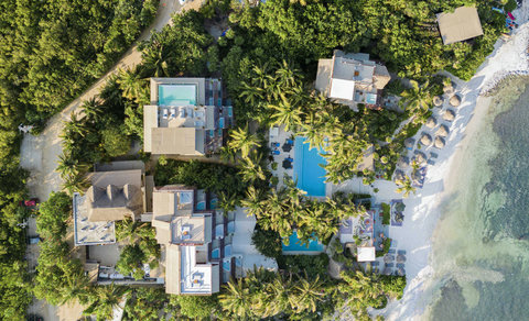 HOTEL VIEWS - From above, boutique sanctuary weaves through palms, pools, and terraces, curating privacy within living jungle patterns.
