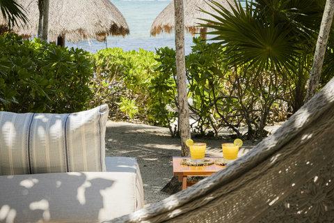 WATERFRONT SUITES - Hammock cradle, twin margaritas glisten, lime scent mingling with salt air while shadows dance across sand.