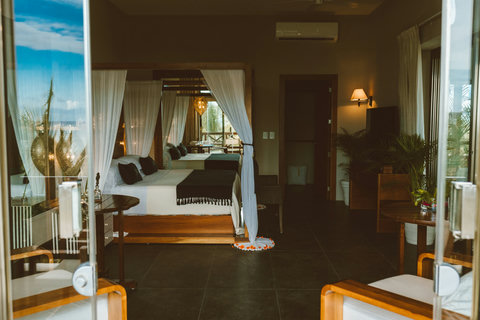 Open-plan suite with canopy bed and terrace