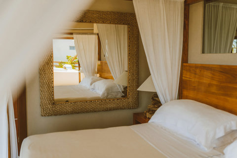 TWIN CROWNS ROYAL SUITE - Bedroom  with decorative mirror and warm lighting