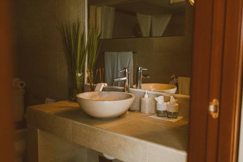 TWIN CROWNS ROYAL SUITE - Warm stone vanity with spa-like essentials
