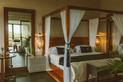 Jasmine Master Suite - Linger beside mirrored walls reflecting hanging lanterns and striped nightstands, while tasselled canopies cradle you in layered comfort — each detail whispering warmth, privacy, and unhurried grace.