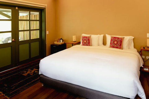 BEDROOM 1 - Embrace tranquility in this cozy retreat, where soft lighting and serene hues create a soothing escape. With plush bedding and elegant decor, your comfort is our priority. Perfect for recharging your soul with nature just outside your window!