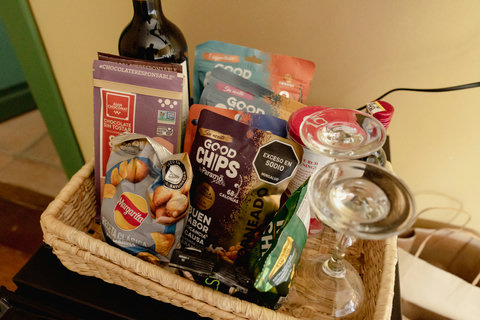 Minibar Chips - Indulge in a cozy retreat where every detail is designed for your relaxation. Enjoy delightful treats and a bottle of wine tucked in a welcoming basket, setting the perfect tone for a luxurious getaway.