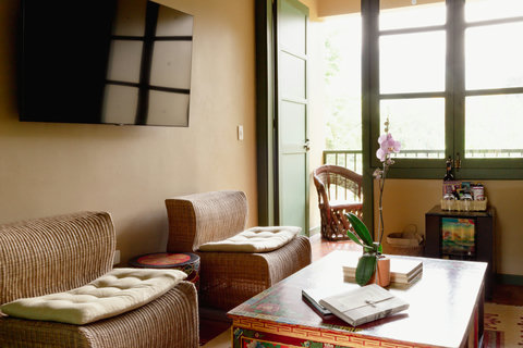 Living room - Bask in the warm glow of this tranquil oasis, where sunlit mornings and cozy comforts invite you to relax and unwind. Enjoy modern amenities and serene views that make this retreat a perfect getaway.