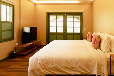 Bedroom - Step into serenity with this charming retreat, where warm hues and soft lighting create the perfect ambiance for relaxation. Unwind on plush bedding or enjoy a cozy night with your favorite shows on the sleek flat-screen TV. Your tranquil esc