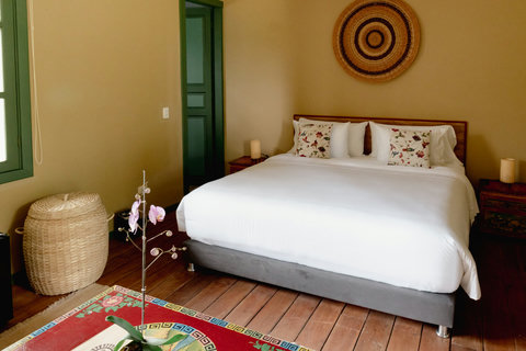 Bedroom - Step into serene elegance with soft, ambient lighting that perfectly complements the cozy warmth of this charming retreat. Relax in the plush bedding surrounded by rustic accents and vibrant decor, creating a peaceful haven just for you.