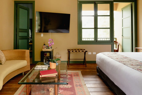 Bedroom - Escape to a cozy oasis where vintage charm meets modern comfort! Bask in the soft glow of natural light filtering through large windows, relax on plush seating, and enjoy top-notch amenities. Your perfect retreat awaits.