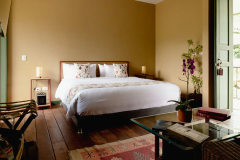 Bedroom - Bask in the serene glow of natural sunlight in this charming retreat, where cozy linens, floral accents, and room to unwind create the perfect escape. 🌿✨