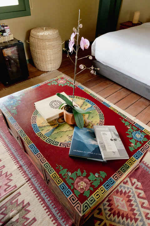 Living Room - 🌿 Step into a world of vibrant tranquility! Bathed in soft, natural light, this serene retreat offers an eclectic blend of rich colors and cozy comforts. Unwind as you sip a warm cup from the mini fridge and let the artistic detailing inspir