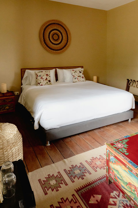 Bedroom - Step into serene comfort with warm hues, soft lighting, and charming decor that invites you to unwind. 🌿 This cozy haven offers a plush king-sized bed and artistic touches, promising a restful stay. Experience tranquility with every detail tho