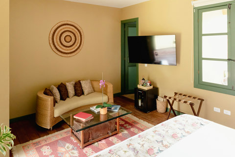 Bedroom - Embrace the perfect blend of comfort and style in this inviting retreat. With warm tones, cozy seating, and vibrant decor, it's an ideal spot for relaxation and unwinding. Enjoy the gentle glow of natural light while indulging in modern ameni