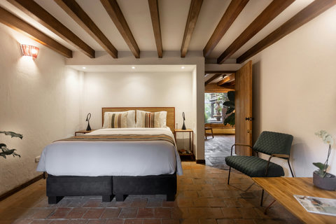 Bedroom 2 - ✨Step into serenity where rustic elegance meets modern comfort. Bask in the warm glow of ambient lighting, relax under charming wooden beams, and savor the lush garden views from your cozy retreat. Perfect for unwinding or inspiring your next