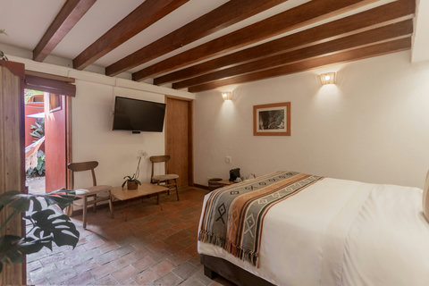Bedroom 1 - Step into serenity at this idyllic retreat, where rustic charm meets modern comforts. Bask in natural light streaming through the patio doors, unwind in the cozy hammock, or sip coffee under warm wooden beams. Your perfect escape awaits!
