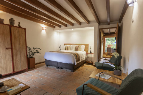 Bedtoom 2 - Step into serene elegance at this tranquil retreat, where warm wooden beams and soft lighting embrace you. Enjoy cozy evenings in luxurious comfort, surrounded by the beauty of nature just beyond the patio doors. Your perfect escape awaits!