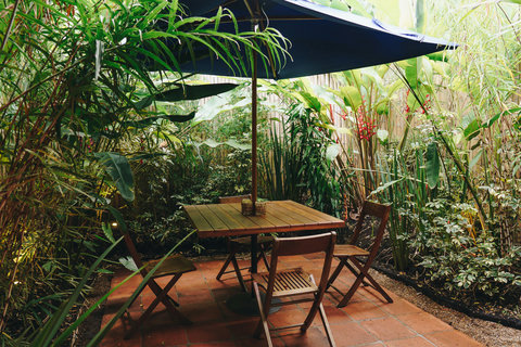 Patio - Unwind in your private tropical oasis where lush greenery and dappled sunlight create the perfect backdrop for morning coffees or sunset dinners. Feel the serenity envelop you as you relax in this enchanting garden retreat.