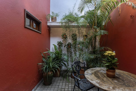 Patio - Step into a serene urban oasis where chic meets tranquil! Bask in the cozy glow of natural light while sipping your morning coffee. This charming courtyard is the perfect slice of paradise, complete with lush greenery and enchanting vibes that pro