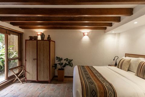 Bedroom 2 - Step into serenity with this charming retreat featuring warm, ambient lighting and rustic beams. Unwind in cozy seating areas and luxuriate in the plush bedding, all while surrounded by nature’s peaceful touch. Perfect for a tranquil escape.