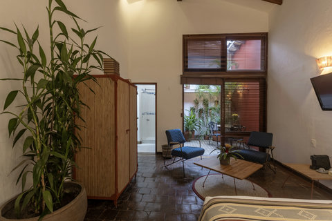 Bedroom 3 - Escape to serenity in this charming oasis where cozy lighting meets warm wooden accents. Bask in the natural light filtering through expansive windows, and unwind in a space designed for ultimate relaxation. Perfect for a retreat, with lush gr