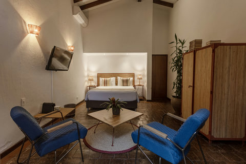 Bedrooom 3 - Step into serenity where natural light meets cozy elegance. Relax in a charming space adorned with warm, ambient lighting and rustic tones. Enjoy a cup of coffee on your private patio nook, surrounded by lush greenery. Your perfect escape awa