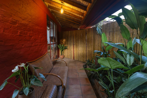 Patio  -  Step into serenity with this charming nook, where ambient lighting meets lush greenery. Unwind in nature’s embrace while enjoying the cozy wicker seating—your perfect retreat from the everyday hustle.