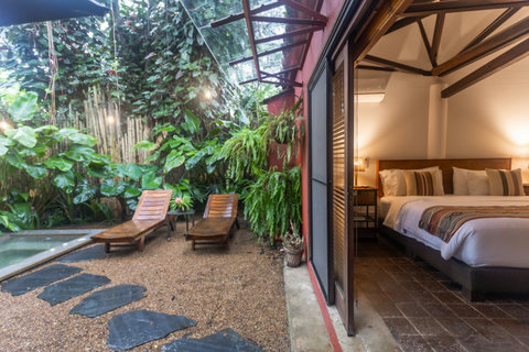 Bedroom to the tub entrance - Escape to paradise in this stunning oasis! 🌿✨ Bask in natural light and lush greenery as you unwind by the private plunge pool. Inside, a cozy sanctuary awaits with inviting comforts that promise relaxation and rejuvenation.