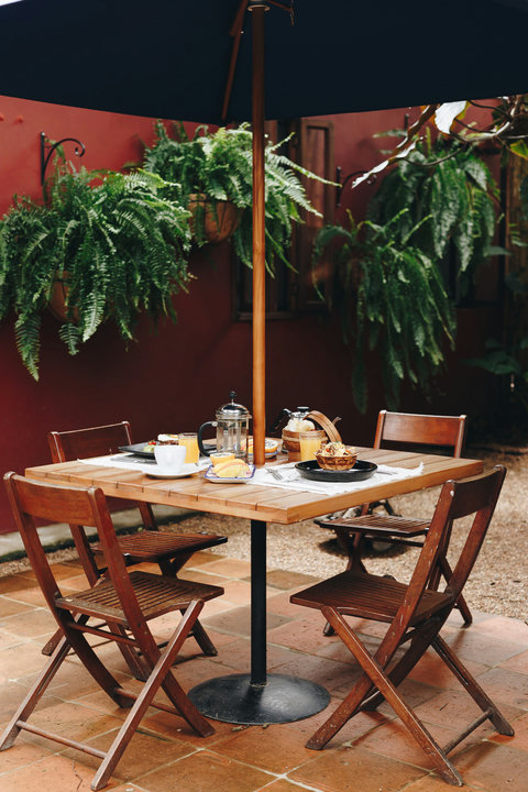 Patio Lunch Area -  🌿 Morning magic awaits in this serene corner of paradise! Indulge in a sun-drenched breakfast under the shade of lush greenery while enjoying all the comforts of home. Unwind, relax, and savor every moment of your stay. ☕✨ #OasisRetrea