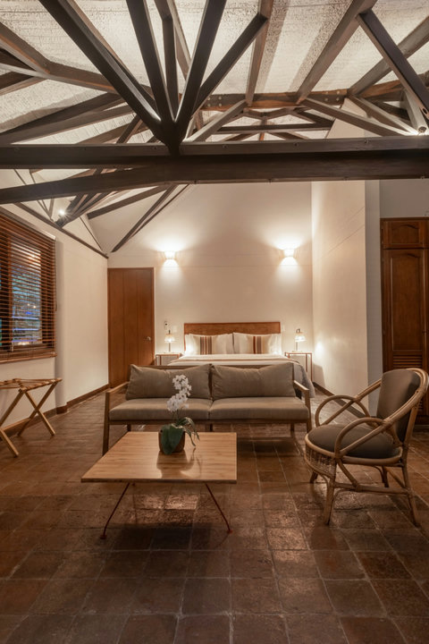 Bedroom 2 - Step into a world of rustic elegance and cozy charm. This serene retreat invites you to relax beneath its stunning, exposed beam ceilings, illuminated by soft, warm lighting. Unwind in the plush seating area or drift off to a restful sleep in